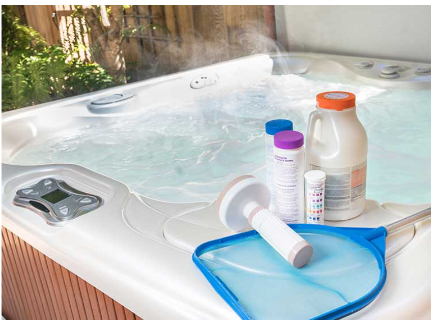 A hot tub with cleaning products balanced on the side